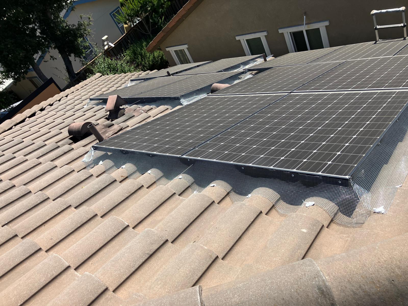Close view of metal exclusion mesh fitted along the edge of solar panels