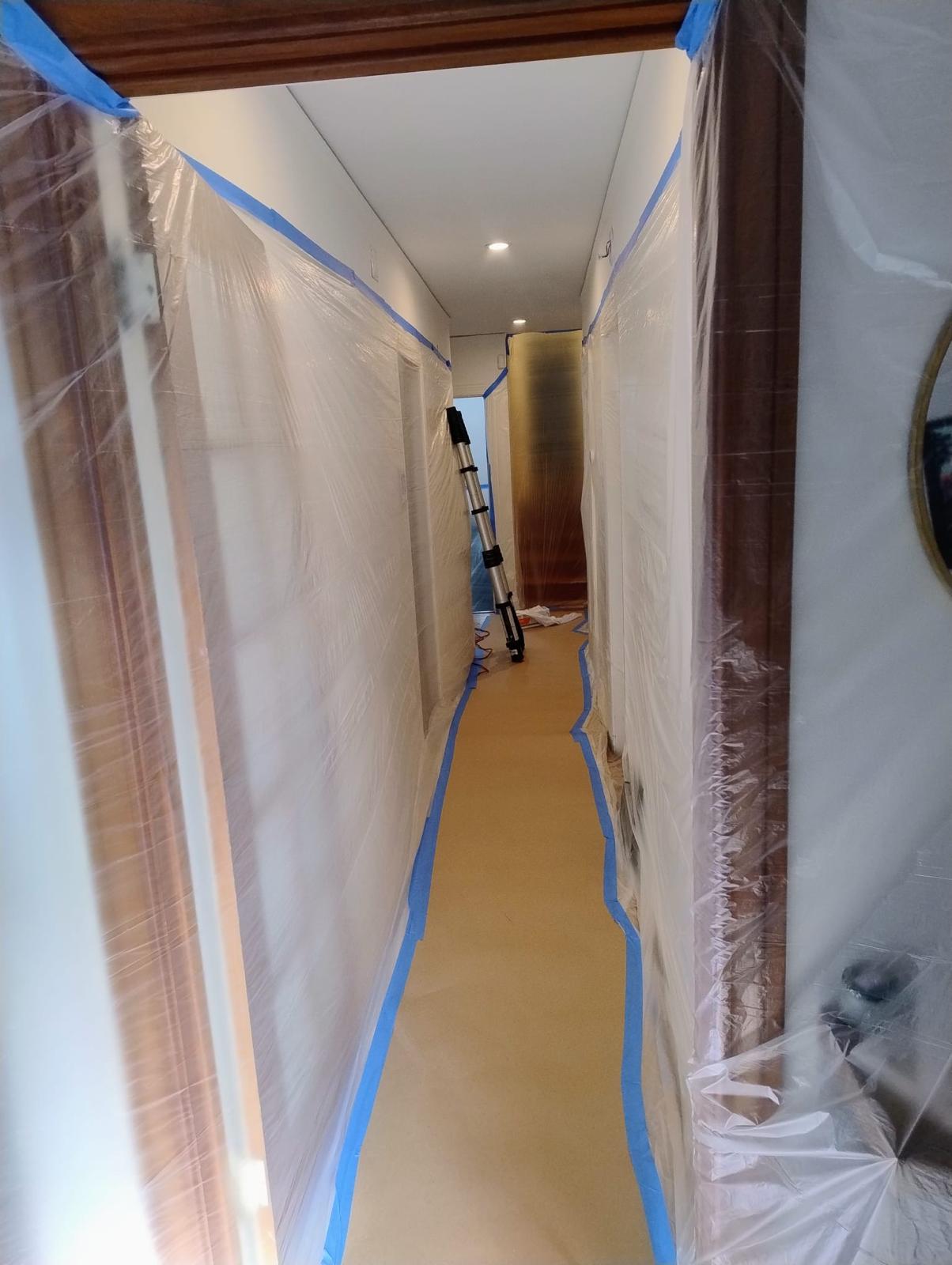 Interior walls and floor protected before crawlspace service materials are moved