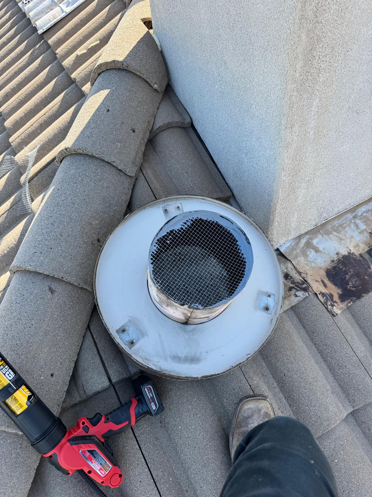 Metal exclusion guard installed over a circular roof outlet
